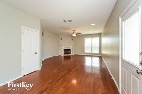 Fort Worth house for rent - A spacious room with wooden floors and white walls.