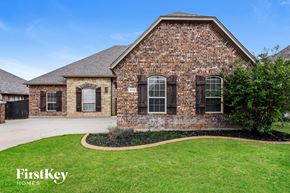 Edmond house for rent - a brick house with a lawn and a driveway