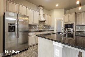 Edmond house for rent - a kitchen with granite counter tops and stainless steel appliances