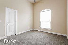 Edmond house for rent - a bedroom with carpet and a door and a window