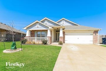 Edmond house for rent - a home with a white garage door and a lawn