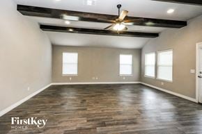 Edmond house for rent - an empty living room with wood floors and a ceiling fan