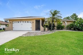 Cape Coral house for rent - A house with a white garage door and a brown roof.