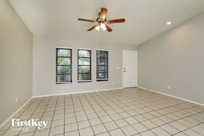 Cape Coral house for rent - A spacious room with a ceiling fan and tiled flooring.