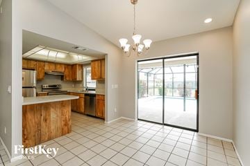 Cape Coral house for rent - A kitchen with wooden cabinets and a tiled floor.
