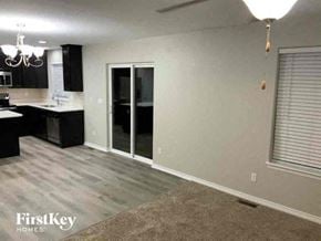 Colorado Springs house for rent - a living room with a kitchen and a sliding glass door