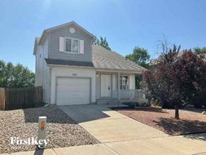 Colorado Springs house for rent - a white house with a driveway and a garage door