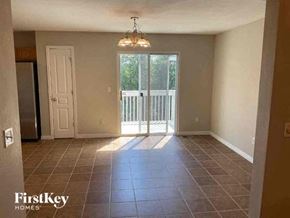 Colorado Springs house for rent - a empty living room with a sliding glass door