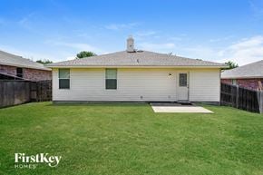 Mckinney house for rent - a white house in a backyard with a grassy yard