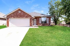 Edmond house for rent - A house with a red brick exterior and a white garage door.
