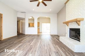 Edmond house for rent - A spacious living room with a fireplace and a ceiling fan.