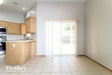 Edmond house for rent - A kitchen with wooden cabinets and a tiled floor.