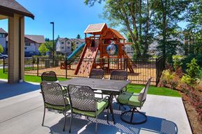 Port Orchard apartment for rent - a patio with a table and chairs in front of a playground