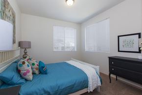 Port Orchard apartment for rent - a bedroom with a bed and a dresser and two windows
