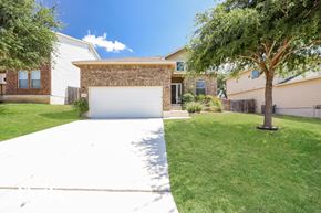 San Antonio house for rent - a white driveway in front of a house with a garage door