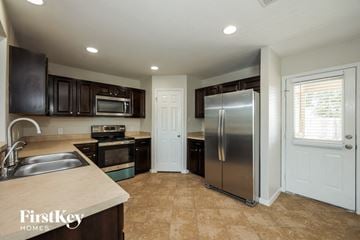 San Antonio house for rent - a kitchen with a stainless steel refrigerator and a sink
