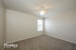San Antonio house for rent - a bedroom with carpet and a ceiling fan