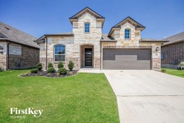 San Antonio house for rent - a large brick house with a garage and a lawn