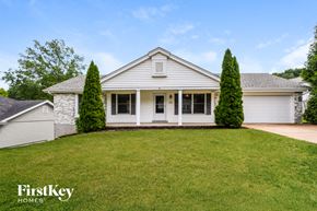 St. Louis house for rent - a white house with a lawn in front of it
