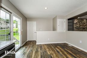 St. Louis house for rent - a living room with wood flooring and a door to a balcony