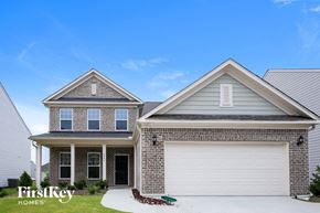 Auburn house for rent - a home with a white garage door in front of it