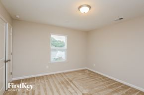 Auburn house for rent - a bedroom with white walls and a white door and a window