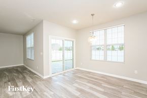 Whitestown house for rent - the living room of a new home with wood flooring and a large window