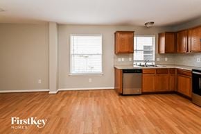Cypress house for rent - an empty kitchen with wooden floors and wooden cabinets
