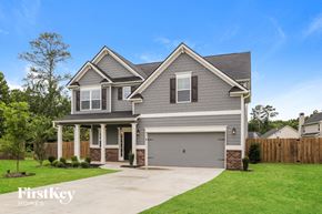 Adairsville house for rent - A two-story house with a garage is showcased in the image.