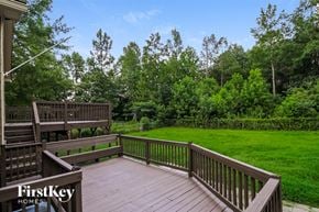 Dallas house for rent - a large deck overlooking a lush green lawn and trees