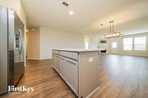 Little Elm house for rent - a kitchen with a large island and a stainless steel refrigerator