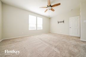 Little Elm house for rent - a spacious living room with carpet and a ceiling fan