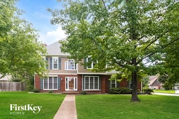 Collierville house for rent - a house with a lawn and trees in front of it