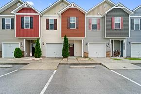 Jacksonville house for rent - A row of houses with garages and driveways.