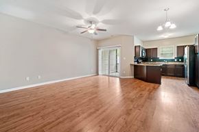 Jacksonville house for rent - A spacious kitchen and living room with wooden flooring and modern appliances.