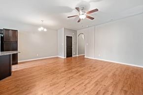 Jacksonville house for rent - A room with a ceiling fan and wooden flooring.