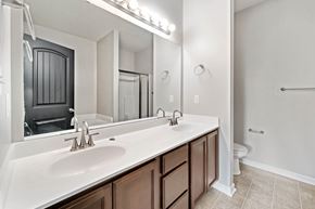 Jacksonville house for rent - A bathroom with a white sink and brown cabinets.