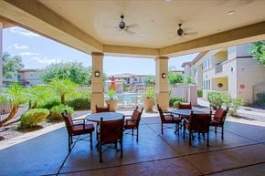 Chandler townhouse for rent - an outdoor patio with tables and chairs and a pool
