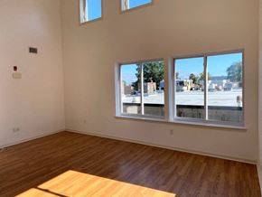 Philadelphia apartment for rent - an empty living room with a wood floor and large windows