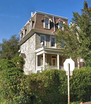 Philadelphia apartment for rent - A large house with a stop sign in front of it.