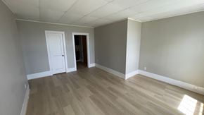 Pictou apartment for rent - an empty living room with gray walls and wooden floors