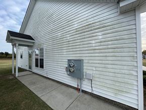 Wilson apartment for rent - A white building with a grey electrical box on the side.