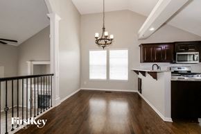 Kansas City house for rent - an empty kitchen and living room of a house with a staircase