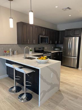 Hackensack apartment for rent - a kitchen with a large island with two stools