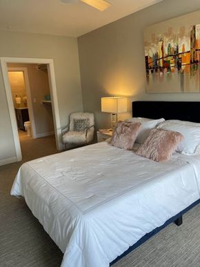 Hackensack apartment for rent - a bedroom with a white bed and a chair
