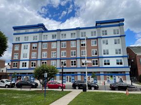 Hackensack apartment for rent - a blue and white building on the corner of a street