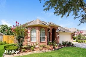 Houston house for rent - A house with a well-maintained lawn and a clear blue sky above.