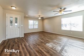 Vail house for rent - A room with wooden floors and a ceiling fan.