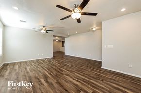 Vail house for rent - A room with a ceiling fan and wooden flooring.