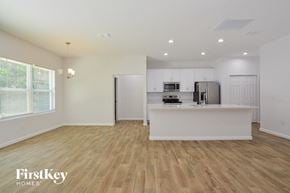 Deltona house for rent - A kitchen with wooden floors and white walls.